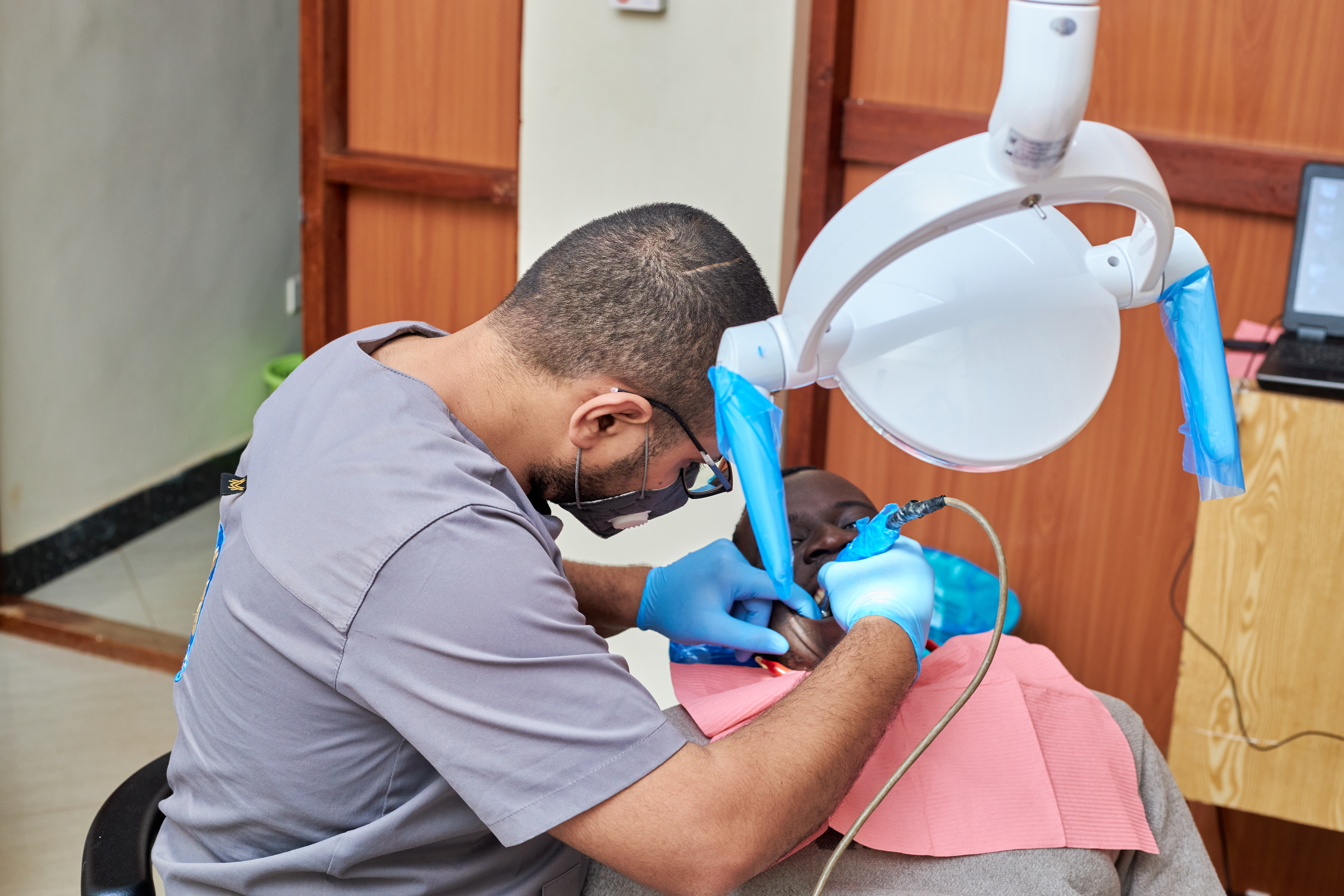 Dentist treating patient at Afripyramid Dental Clinic in Mbarara